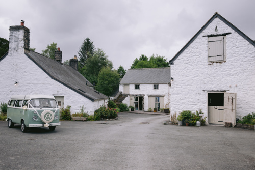 mint green VW camper van parked outside of Hafod Farm wedding venue