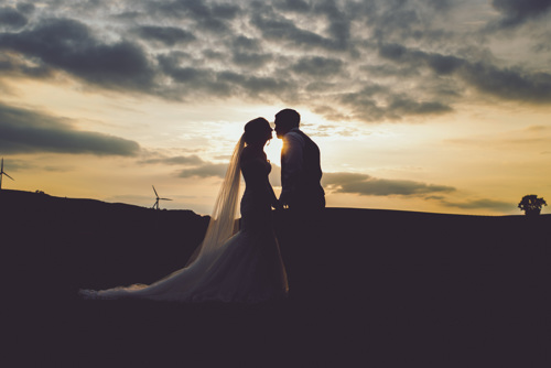 Silhouette of Bride & Groom, as they kiss at sunset in North wales