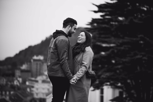 Couple laugh during pre wedding shoot in Llandudno North Wales