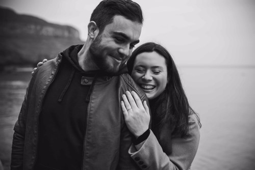 Couple hug and laugh during pre wedding shoot in Llandudno North Wales