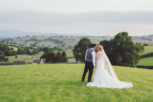 Bride & Groom overlook welsh mountains during wedding