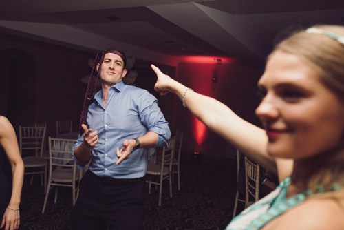 Wedding guest dances with tie around his head at Rossett Hall wedding