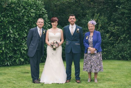 Bride & Groom family photograph with their parents at Highfield Hall wedding
