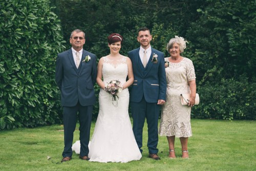 Bride & Groom group photograph with their parents at Highfield Hall wedding