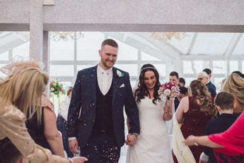 Bride & Groom walk up aisle after wedding ceremony at Lion Quays