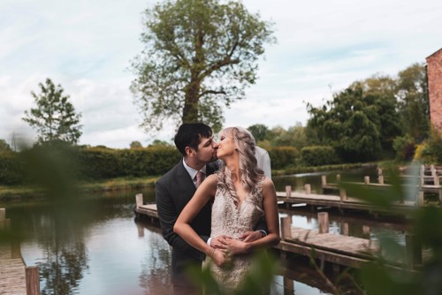 Bride & Groom kiss near canal at Lion Quays Hotel