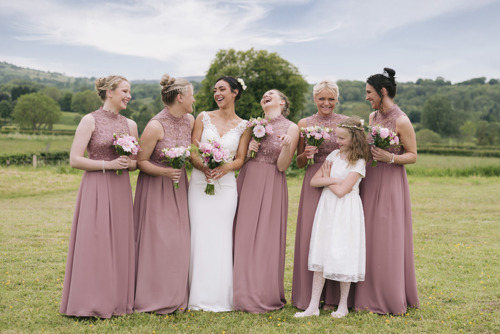 Bridal party laugh during wedding portraits in Ruthin, North Wales